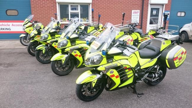 Five blood bikes stood up in a row