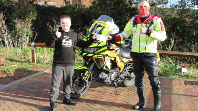 Pictured here is Donna's son, Callum Teal, presenting the cheque to Dave Cook, a volunteer rider with Devon Freewheelers. Photo with permission: Alan Quick, Crediton Courier. 