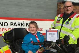 Pictured here is Elsie Horn, aged six, being presented with her certificate of thanks by Devon Freewheelers deputy CEO, Russell Roe. Photo: Devon Freewheelers