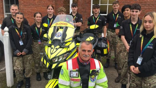 Photo shows: Devon Freewheelers volunteer Dave Cook Military with the Protective Services Academy students, at Bicton College, in East Devon. Credit: Devon Freewheelers.