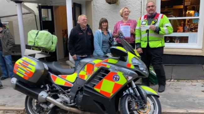 Devon Freewheelers volunteer Mick Scaife is presented with a cheque for the charity thanks to the Quarryman's Rest, in Bampton, near Tiverton.Photo: Jon Walker-Morecroft 